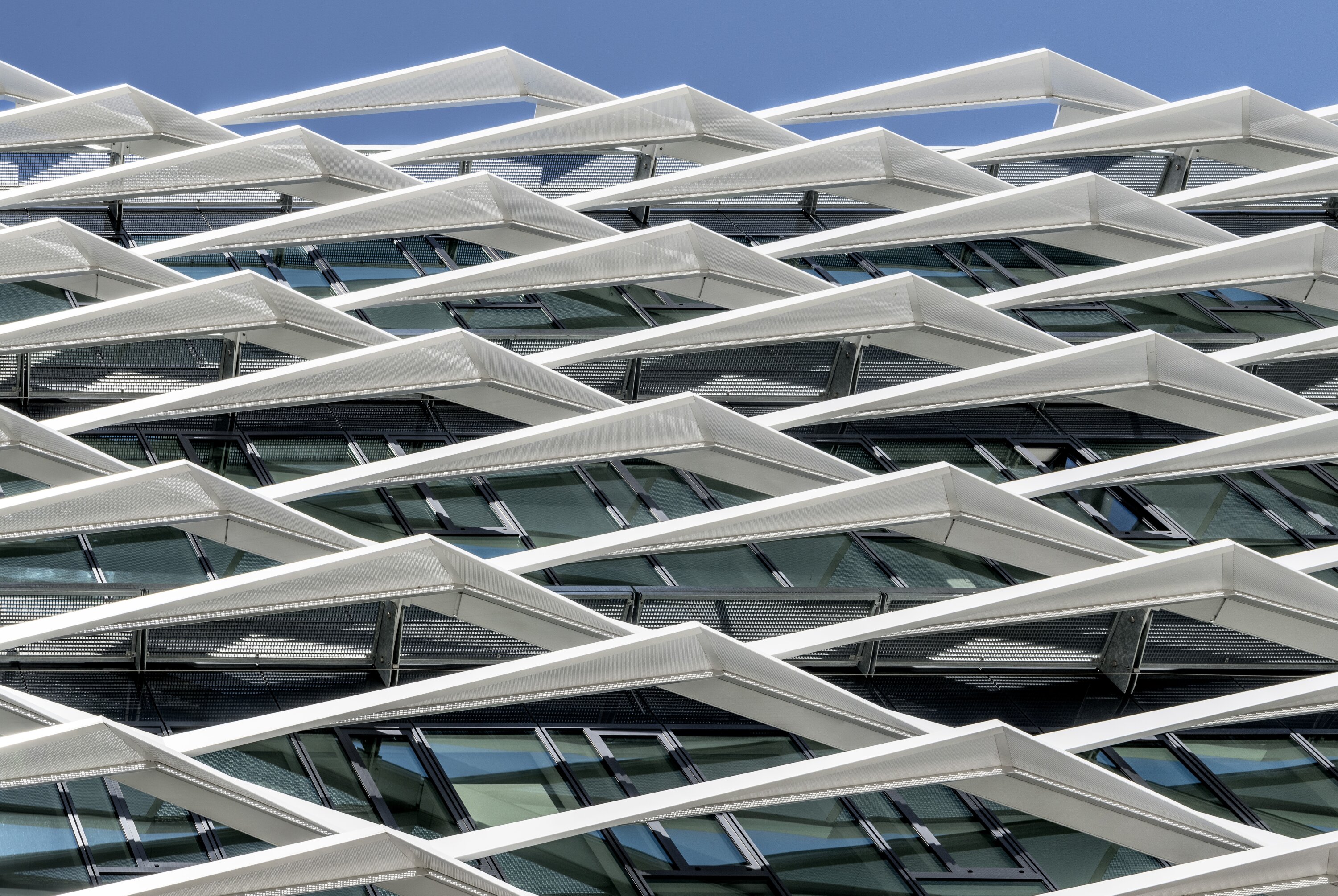 Project by Behnisch Architekturbuero, adidas ARENA. Grid-like facade features it is a specially designed sun protection and shading system.