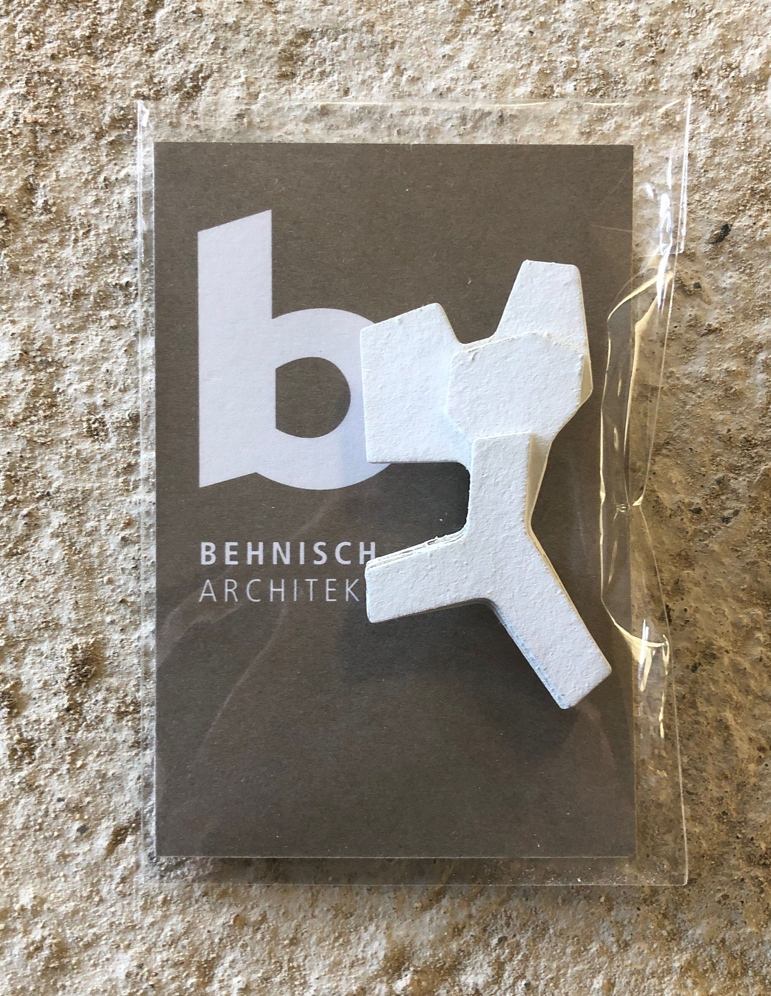 Project by Behnisch Architekturbuero, Lurup Neighborhood School. The Behnisch Logo with a small model of the building.