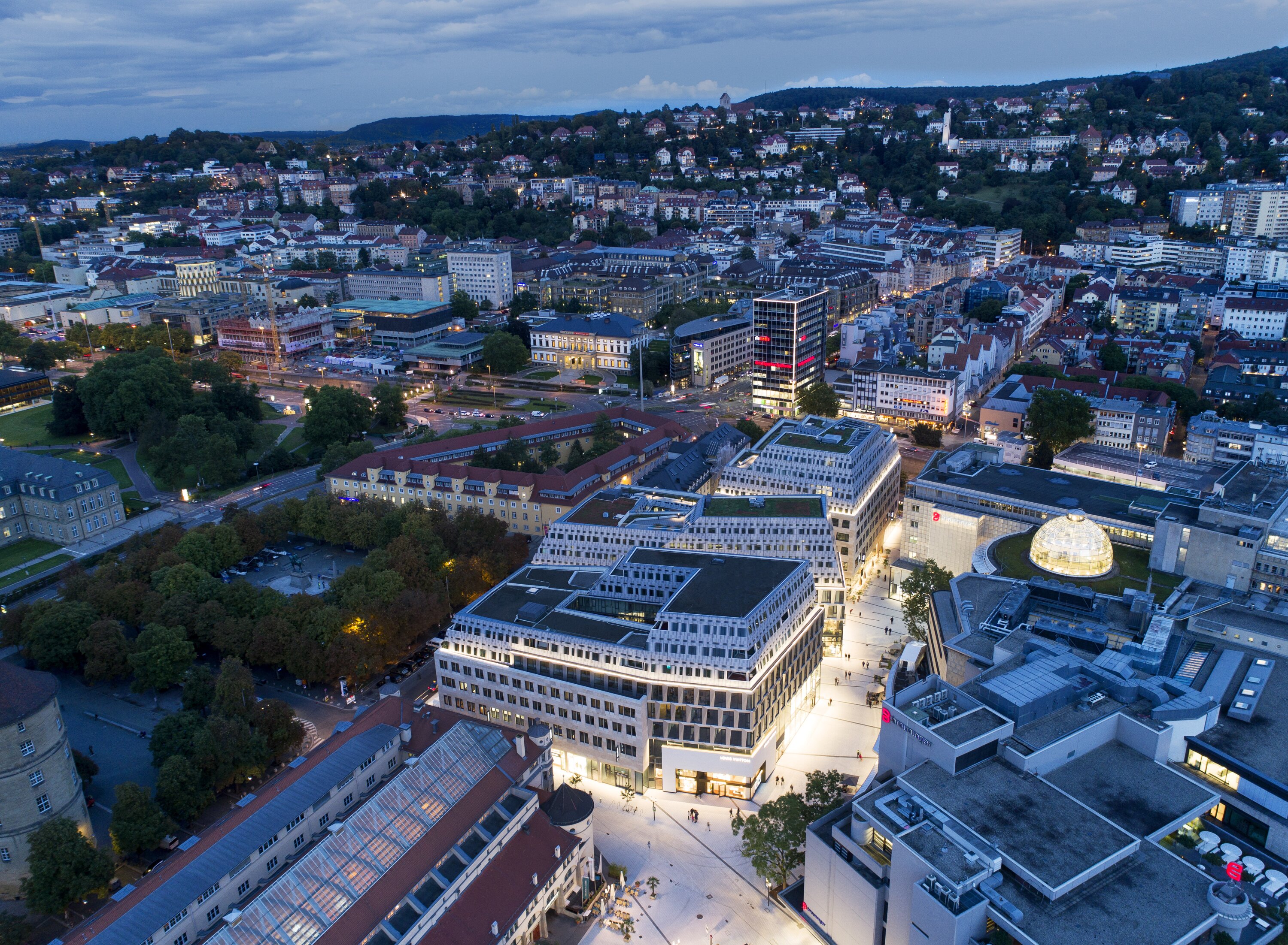 Project by Behnisch Architekturbuero, Dorotheen Quartier. Night view from the air, showing how the building blends into the surrounding cityscape.